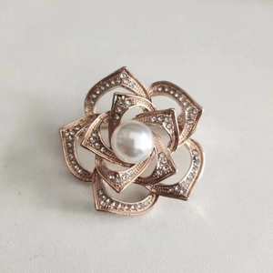 Vintage rose gold camellia brooch with sparkling rhinestones and a center pearl detail