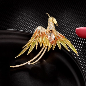 Broche phénix élégante en or avec émail orange et cristaux de champagne étincelants