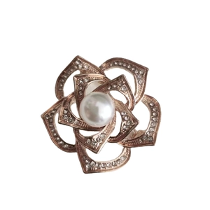 Vintage camellia brooch in rose gold with a center pearl and crystal petals