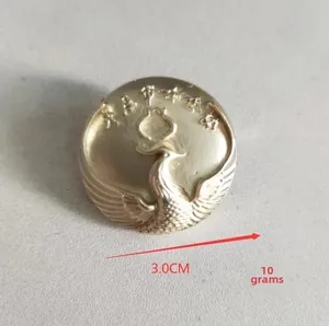Detailed macro view of 3.0cm vintage matte gold phoenix brooch with traditional patterns