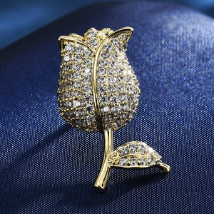Macro shot of tulip brooch with sparkling pavé crystals and elegant gold finish