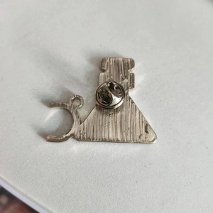 Back view of silver chemistry beaker brooch with brushed metal finish and butterfly clasp