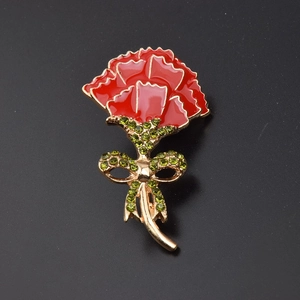 Elegant red carnation brooch with gold trim and green rhinestone bow detail