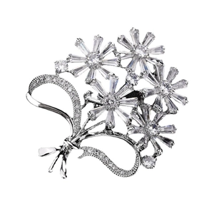 Elegant silver daisy flower brooch with sparkling cubic zirconia crystals and ribbon bow