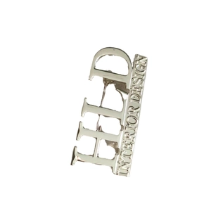 Silver metal HLD Interior Design letter brooch with a modern minimalist style and pin back
