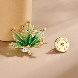 Elegant gold maple leaf brooch with green gradient enamel and sparkling white rhinestone