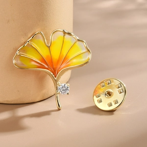 Exquisite golden ginkgo leaf brooch with orange enamel and sparkling zircon stone inlay