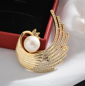 Elegant gold phoenix wing brooch with large white pearl and sparkling crystals