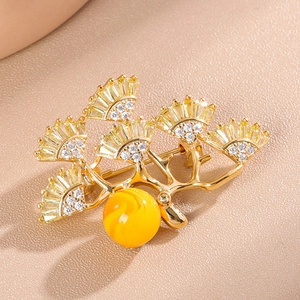 Elegant pine tree brooch in gold finish with freshwater pearls and yellow zircons