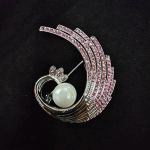 Elegant phoenix tail brooch with pink rhinestones and a large white pearl centerpiece