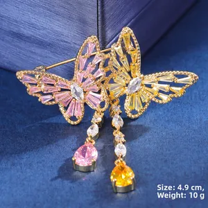 Detail view of double butterfly brooch with pink and yellow zircons and dangling tassels