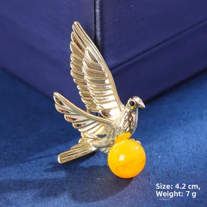 Detail showing elegant gold bird brooch with amber bead, weight 7g and size 4.2cm