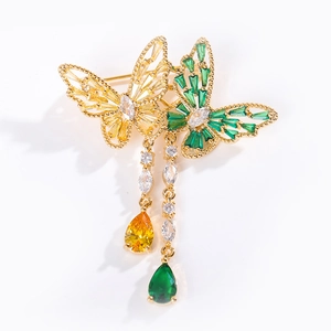 Elegant gold butterfly brooch with yellow and green crystals and hanging tassel chains