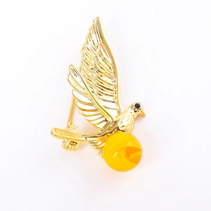 Elegant gold bird brooch with amber-style resin bead and delicate feather texture details