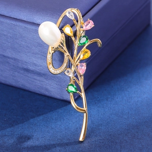 Exquisite orchid brooch with gold alloy base and colorful zircons on a dark box