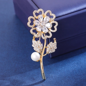 Elegant sunflower brooch with sparkling cubic zirconia and pearl on jewelry box