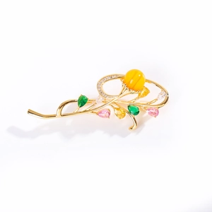 Elegant gold orchid brooch with colorful gemstones and yellow bead for classic coats