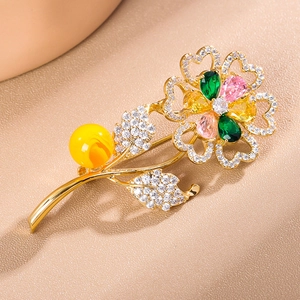 Elegant sunflower brooch with colorful gemstones and pearls in golden metal base