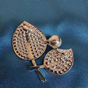 Elegante spilla a foglia dorata con perla e chiusura a spillo su seta blu
