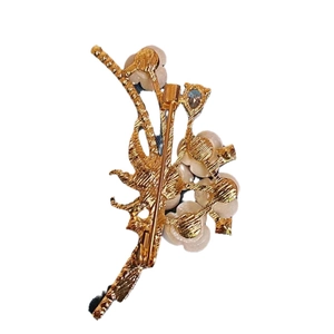 Elegant gold flower brooch with white beads featuring a vintage branch design and pin back