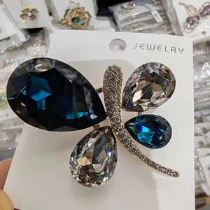 Elegant dragonfly brooch pin with blue crystal wings and sparkling white rhinestones