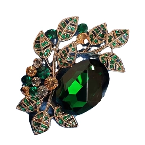 Elegant emerald crystal leaf brooch pin in gold finish for luxury fashion styling