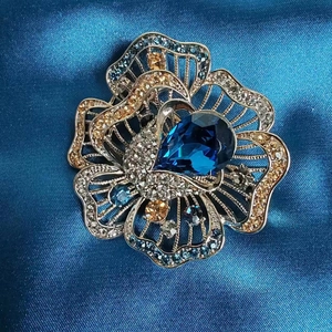 Elegant flower brooch with blue crystal and rhinestone petals for luxury coats