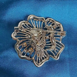 Back view of flower brooch with sky blue crystal petals and secure pin clasp closure