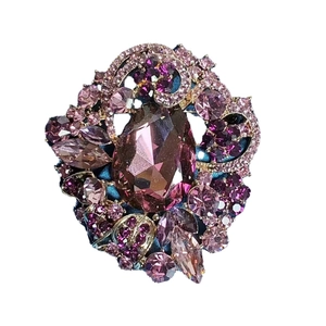 Elegant vintage Bohemian brooch featuring a large purple teardrop crystal and floral pattern