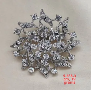Detail of silver floral brooch with clear rhinestones measuring 5.3x5.3cm and 19g weight