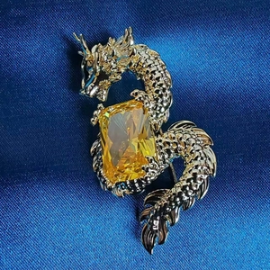 Exquisite golden dragon brooch with micro-pave zircon and a large yellow gemstone