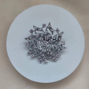 Elegant silver floral brooch with spiraling petals and sparkling crystal rhinestones for formal wear