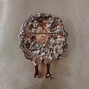 Exquisite sheep-shaped brooch with textured rose gold finish on champagne satin fabric