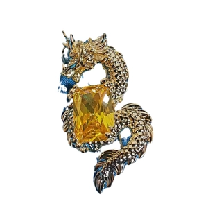 Exquisite golden dragon brooch with a large yellow gemstone inlay for elegant outfits