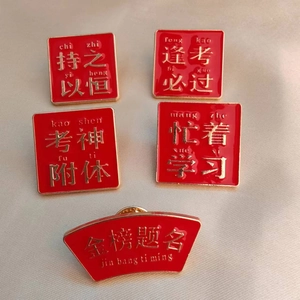 Detailed view of red and gold Chinese motivational metal pins for student exams
