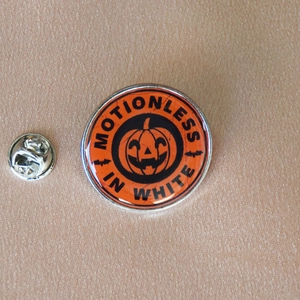 Detail of Motionless In White Halloween pumpkin enamel pin with silver butterfly clutch