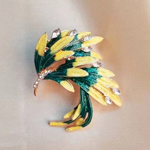 Elegant gold feather brooch with green enamel and sparkling rhinestones for suits