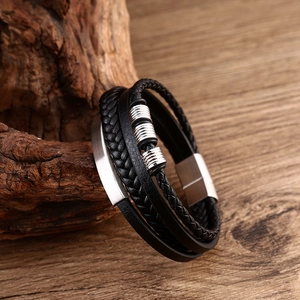 Detail view of multi-layer black leather bracelet with silver metal beads and magnetic clasp