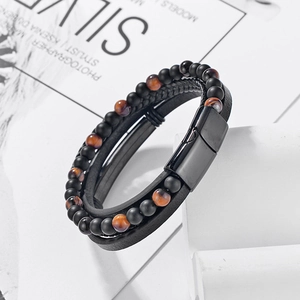 Detail of multi-layer men's leather bracelet with tiger eye beads and black magnetic clasp