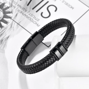 Men's black braided leather bracelet with black magnetic clasp on white stone platform