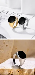Close-up of vintage punk square black enamel signet ring in gold and silver finish