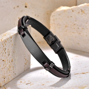 Men's braided leather bracelet with black matte stainless steel bar on stone display
