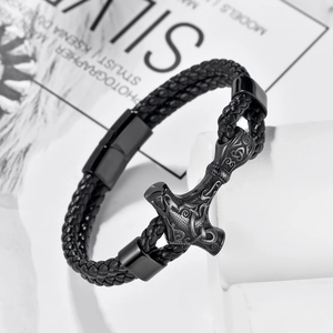 Close-up of Viking Mjölnir pendant on black braided leather strap with magnetic clasp