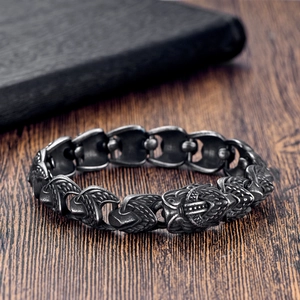 Macro detail of vintage punk beast head links on an oxidized stainless steel chain bracelet