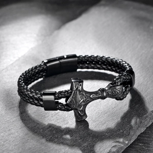 Detail of Viking Thor hammer pendant on braided black leather bracelet with magnetic clasp