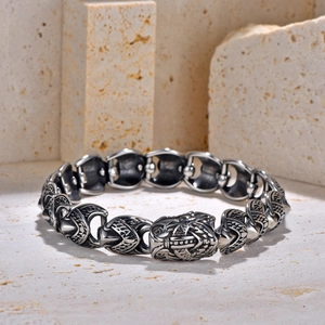 Macro view of retro owl head link chain bracelet in distressed silver stainless steel