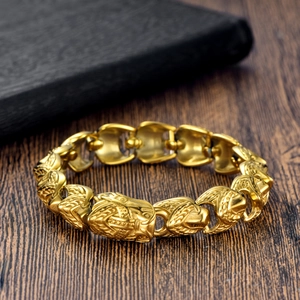 Detail of vintage gold punk chain bracelet with intricate beast head carvings on links