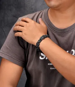 Detailed close-up of men hip hop punk black stainless steel dragon scale link chain bracelet