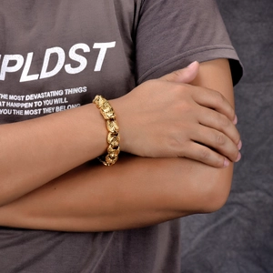 Close-up detail of golden hip-hop punk link bracelet with intricate dragon scale textures
