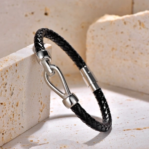 Men's braided black leather bracelet with silver horseshoe magnetic buckle on stone